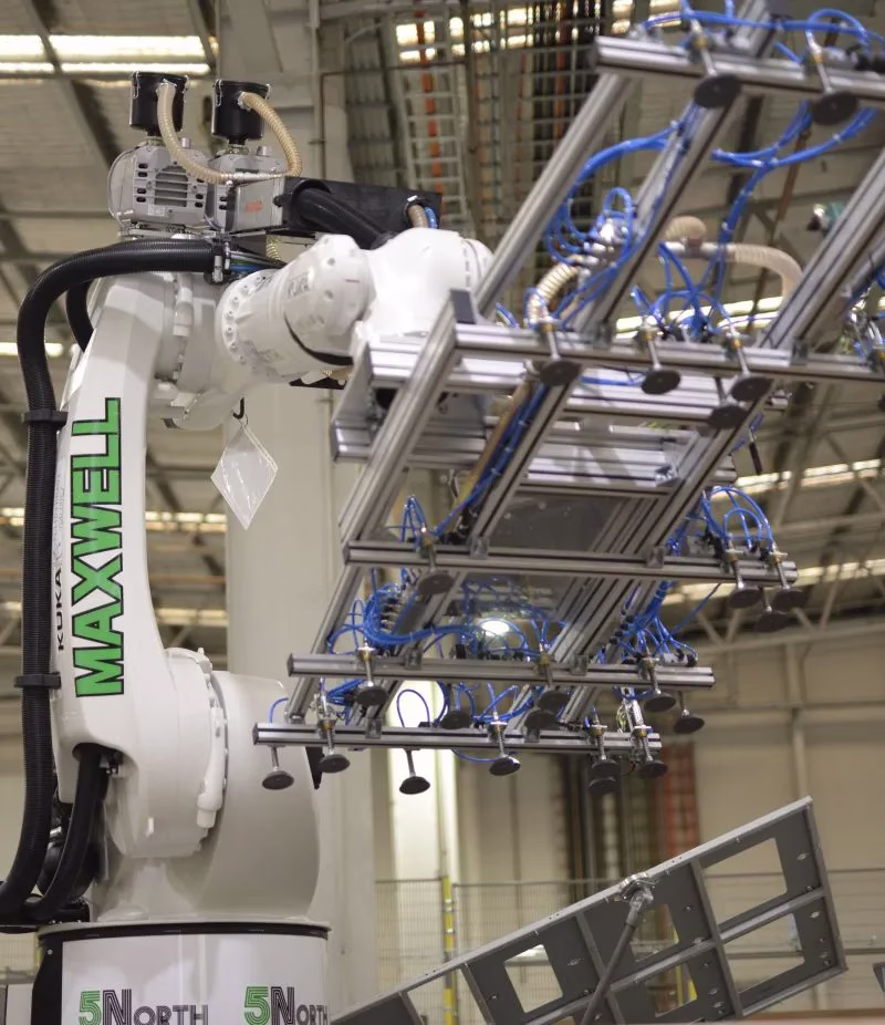 A robotic gantry positioning a steel frame in the 5North facility